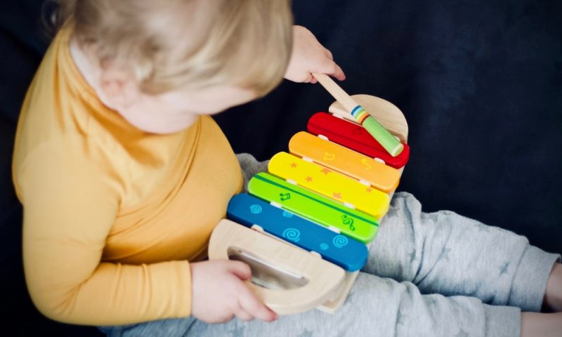 Toddler playing with a xylophone