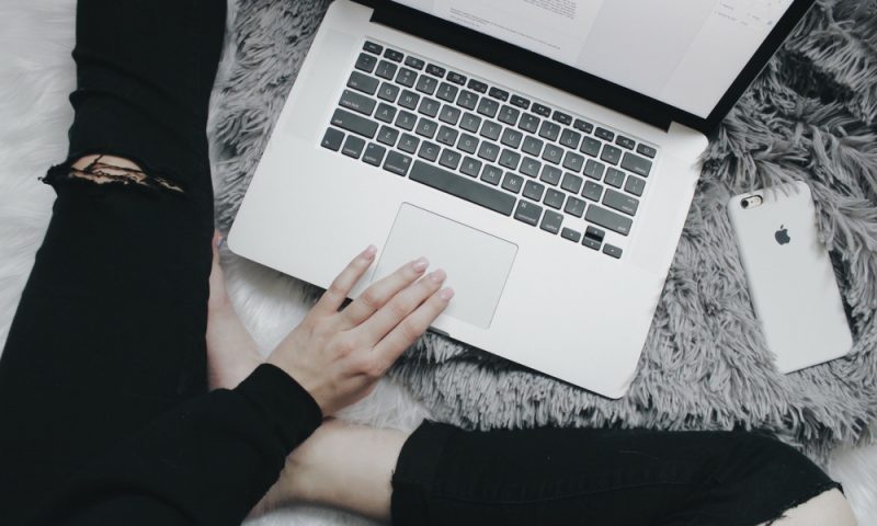 Lady with laptop and phone blogging