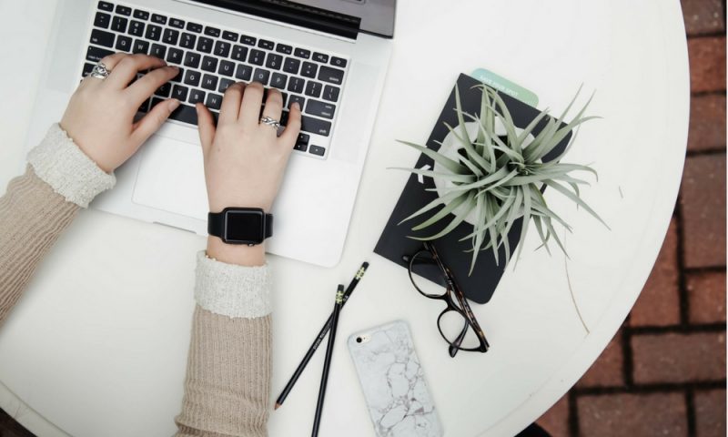 Lady working at her laptop writing blog content
