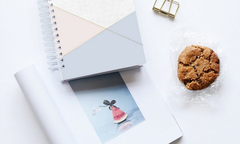 Laptop, coffee and notebook all things required for a blogger