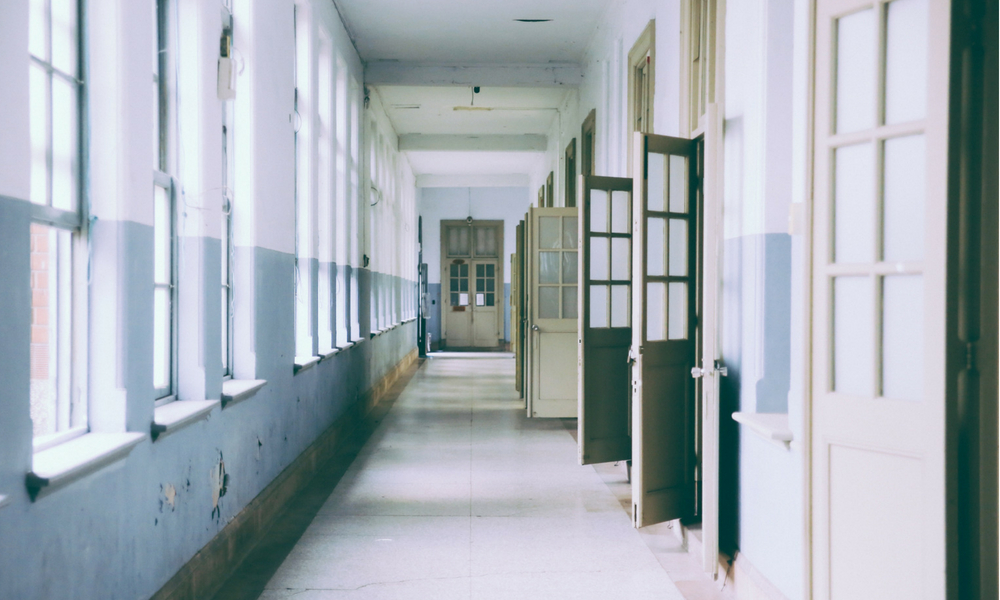 School corridor featuring lots of open doors